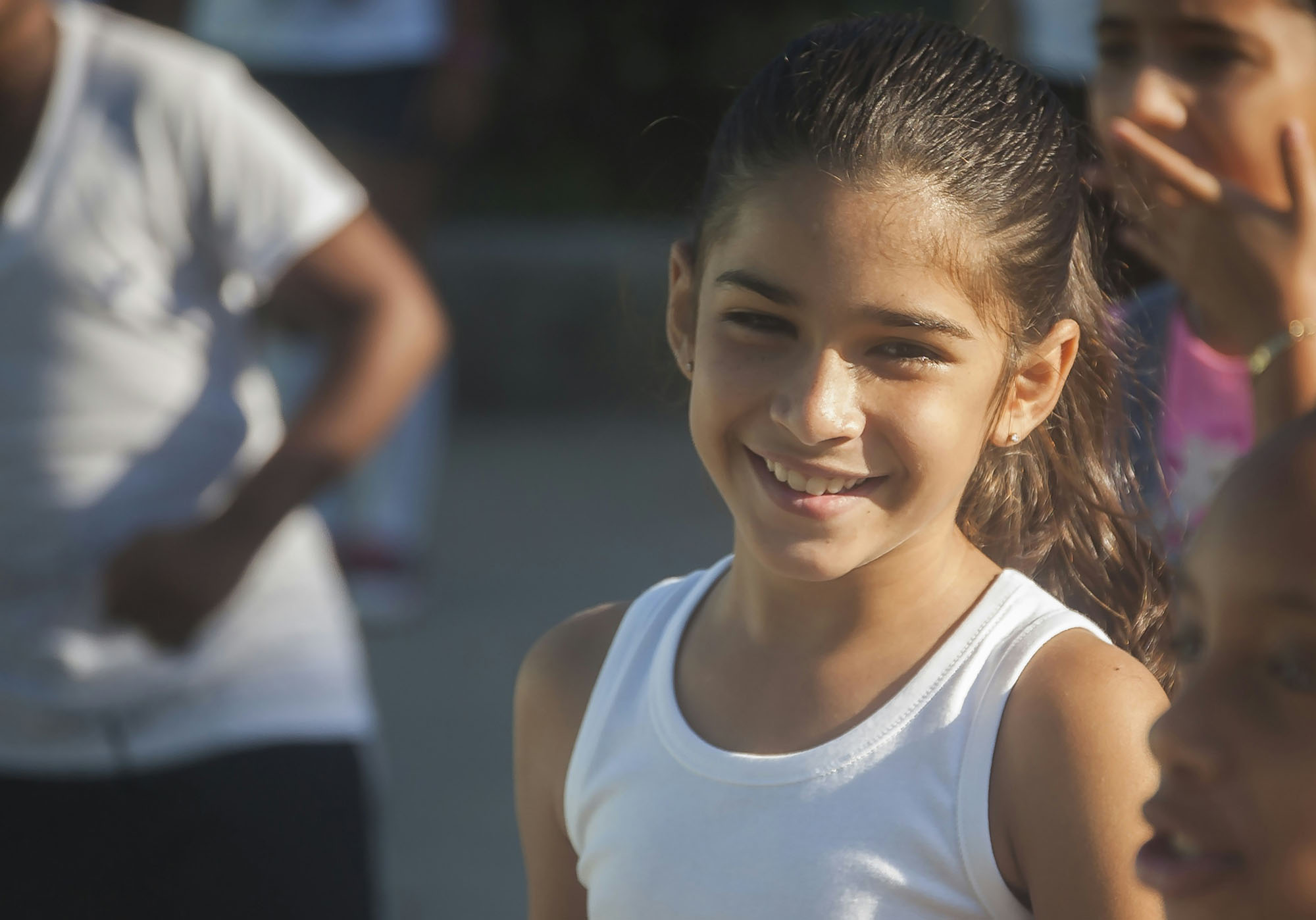 a young girl smiling at the camera